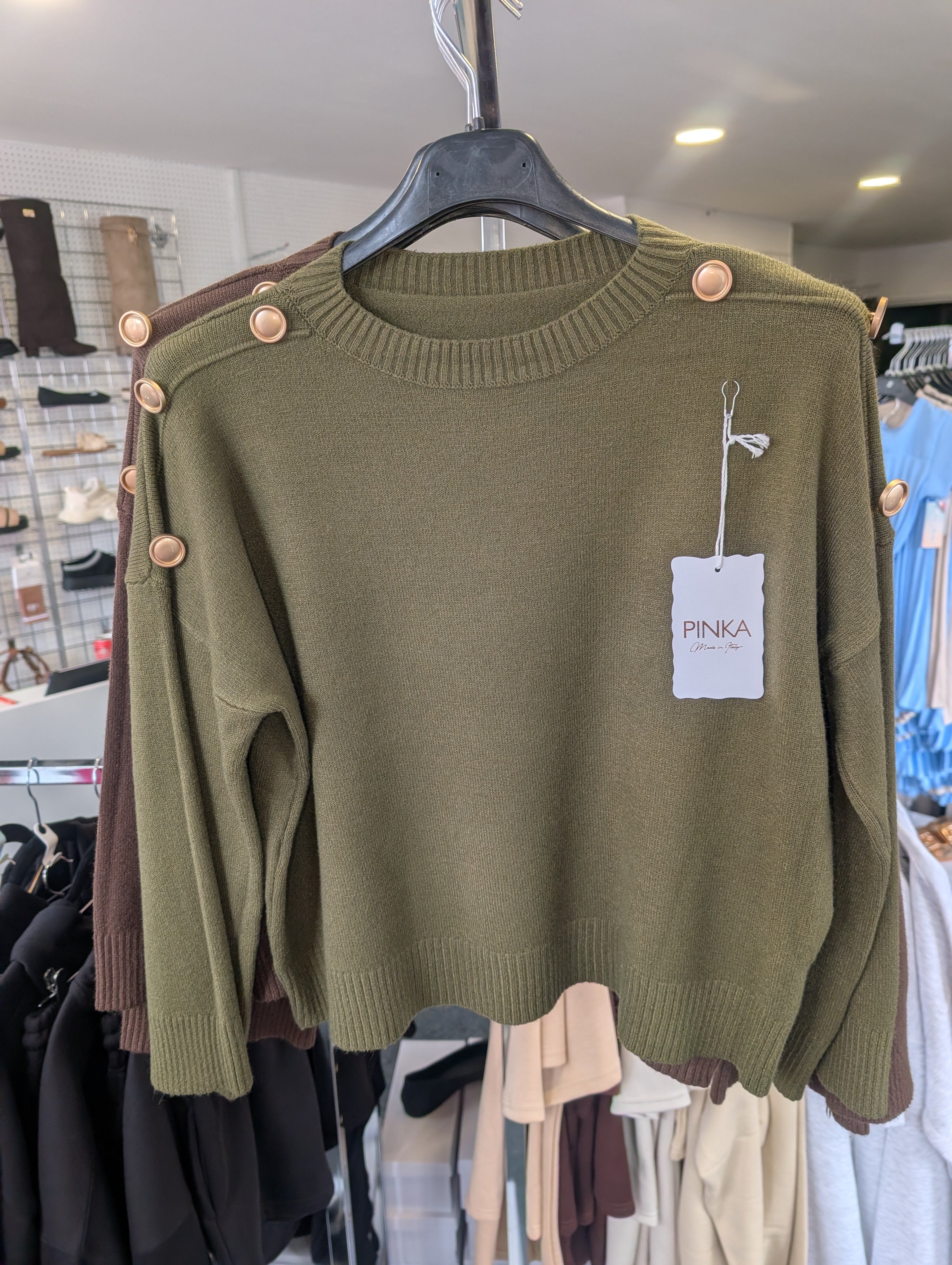 Long-Sleeved Knitted Sweater Features A Round Neckline And Distinctive Gold-Tone Decorative Buttons
