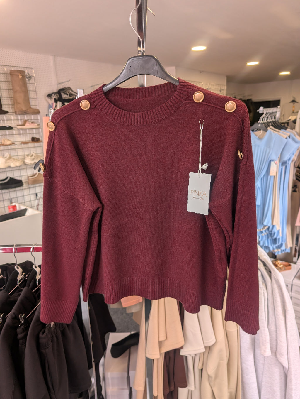 Long-Sleeved Knitted Sweater Features A Round Neckline And Distinctive Gold-Tone Decorative Buttons