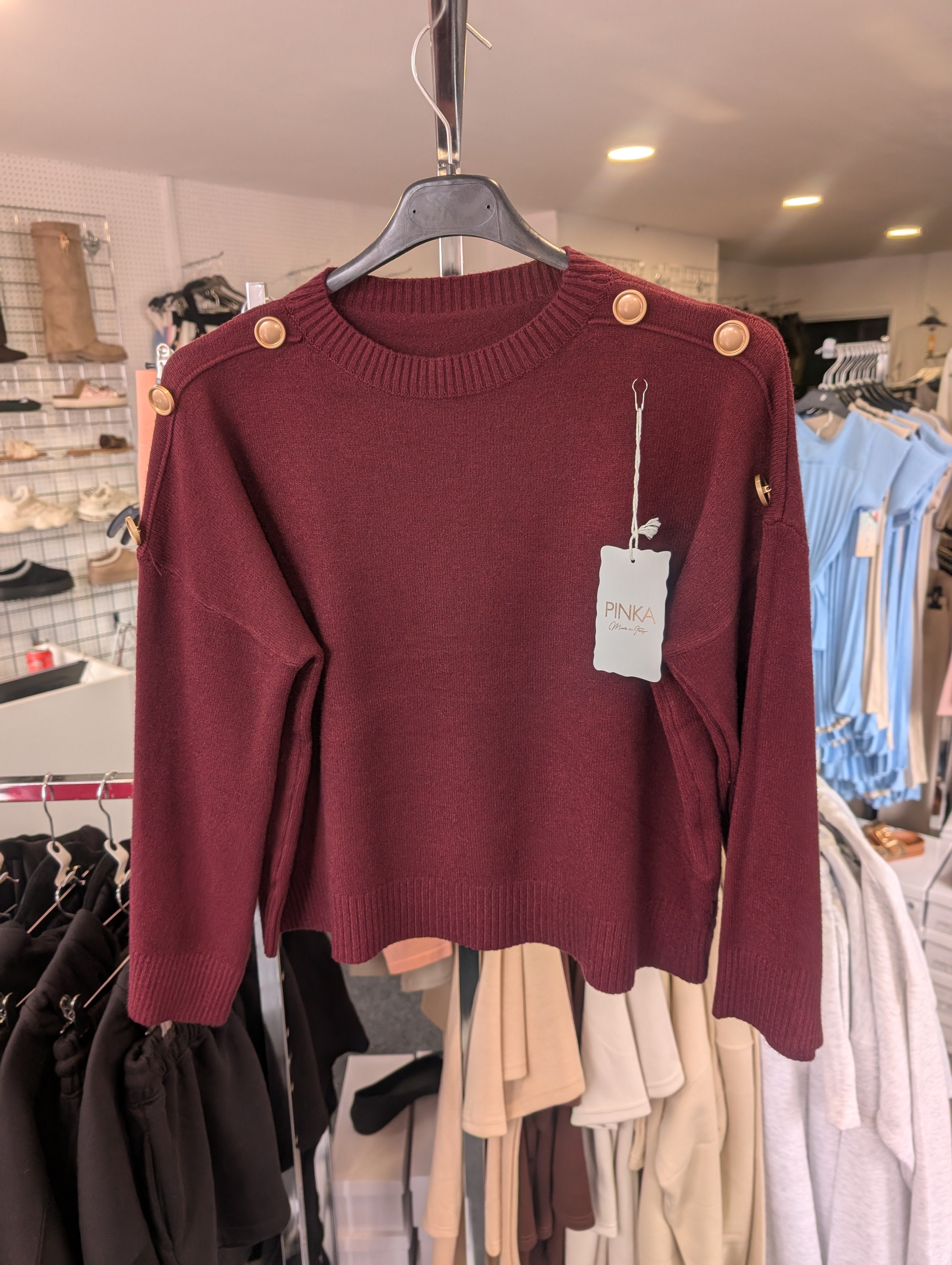 Long-Sleeved Knitted Sweater Features A Round Neckline And Distinctive Gold-Tone Decorative Buttons